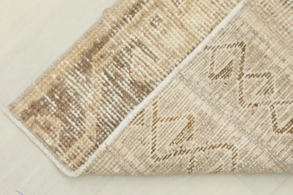 View of the rug's reverse side and pile, showing the hand-knotted construction.
