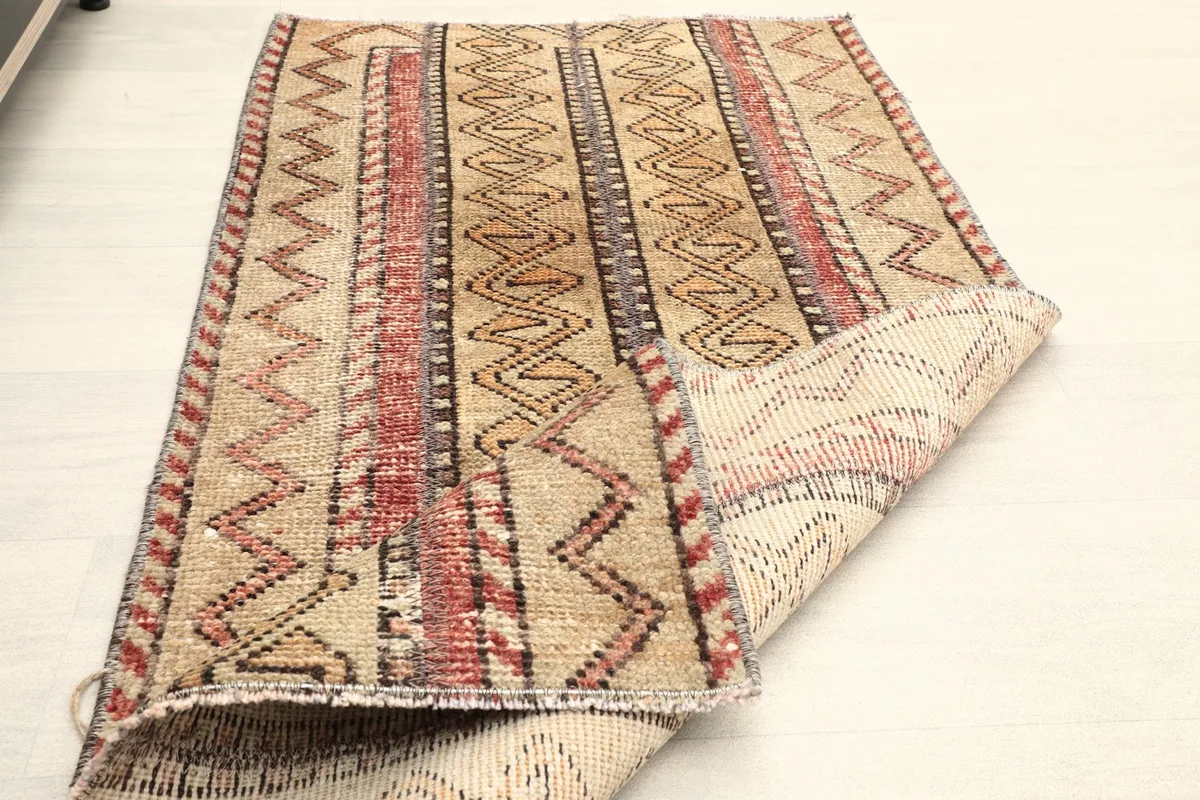 The rug folded to show its flexibility and the density of the hand-knotted wool pile.