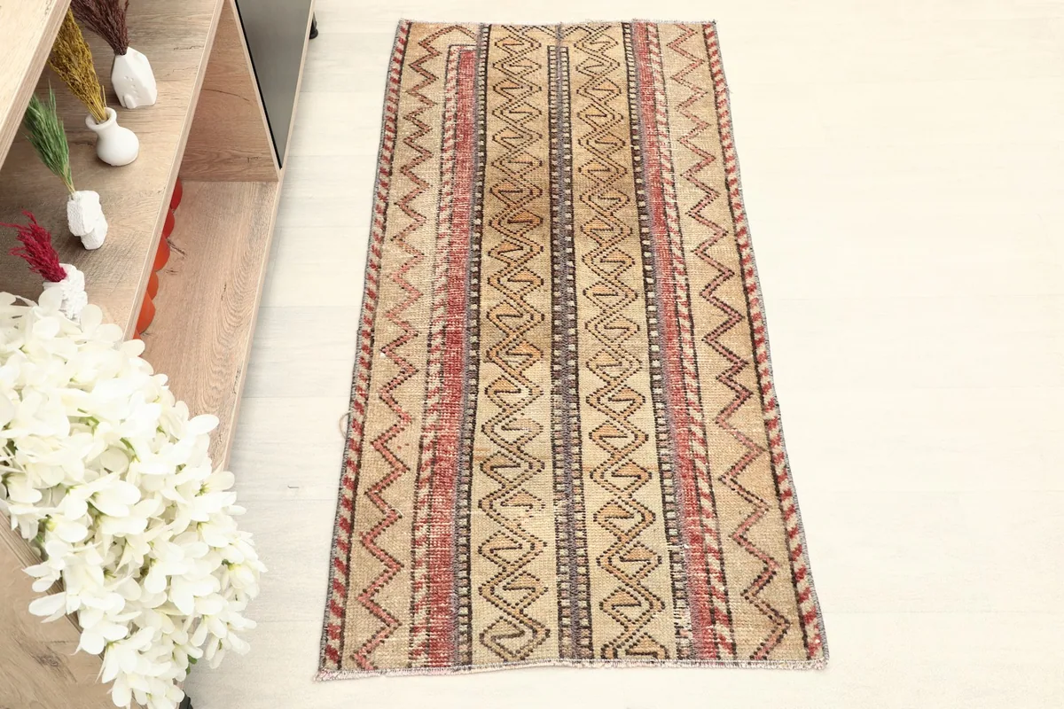 Overhead view of the vintage Anatolian rug, highlighting its beige field with rust and brown stripes.