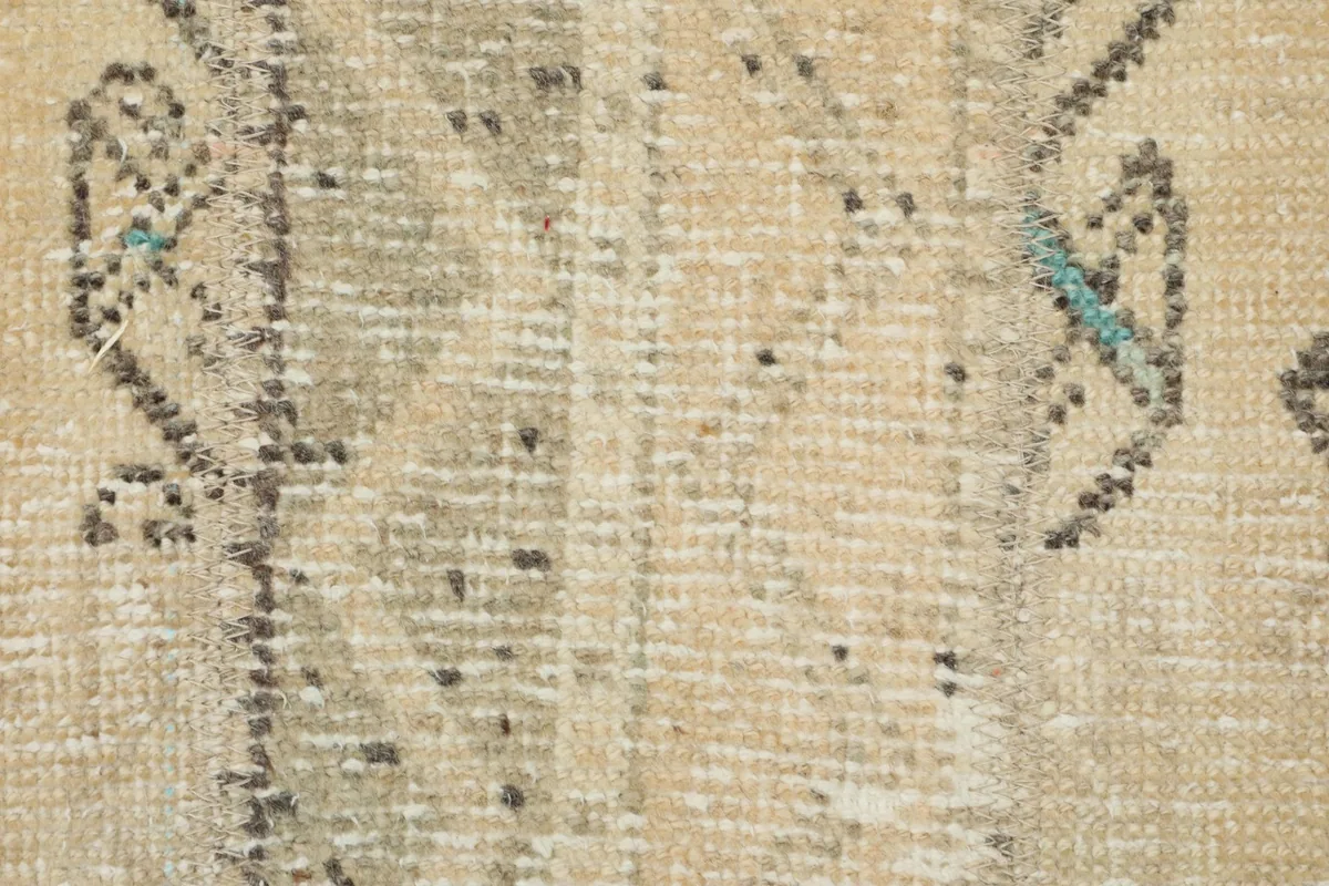 Extreme close-up of the wool pile, revealing individual knots and the distressed appearance.