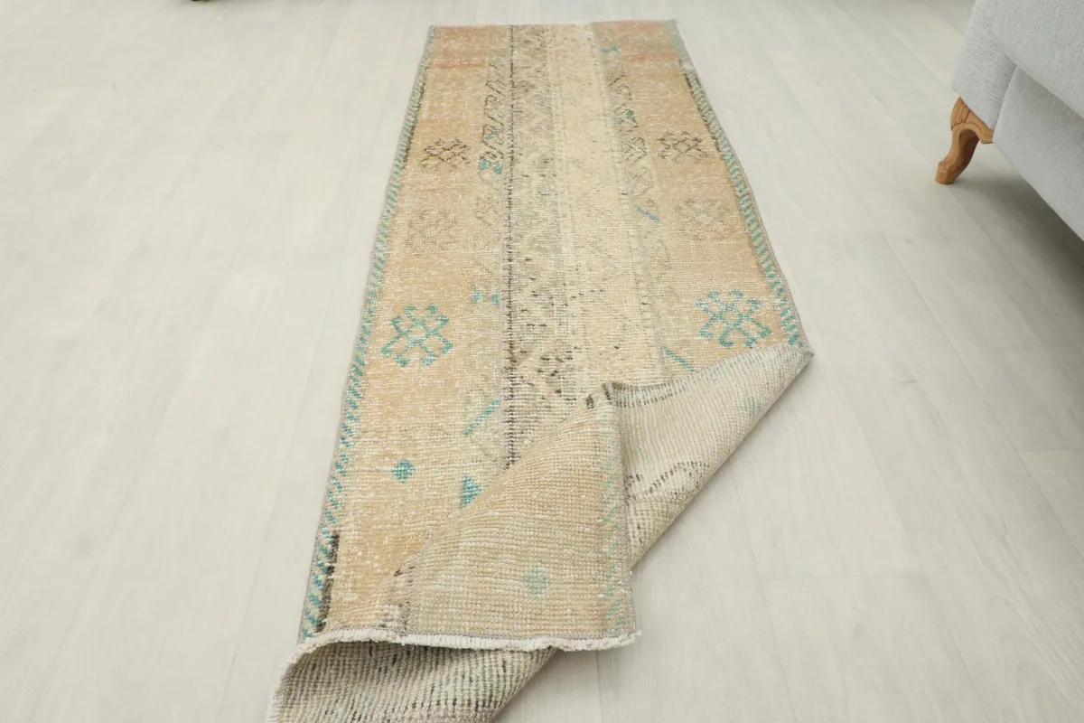 Angled view of the runner rug with one end gently folded back, showing its flexibility.