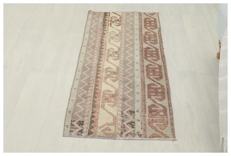 Full top view of the beige, gray, and rust vintage Anatolian area rug.