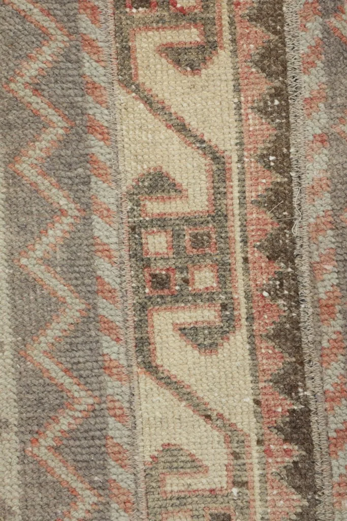 Detailed view of a central geometric motif within the rug's striped design.