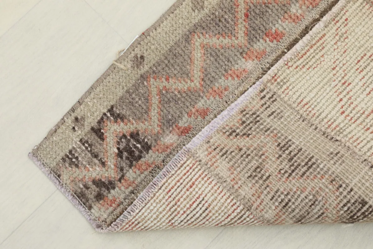 View of the back of the rug, showing the cotton foundation and hand-knotted construction.