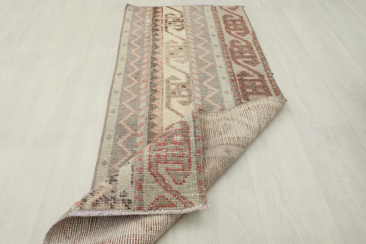 Rug partially folded, displaying both the pile side and the cotton foundation.
