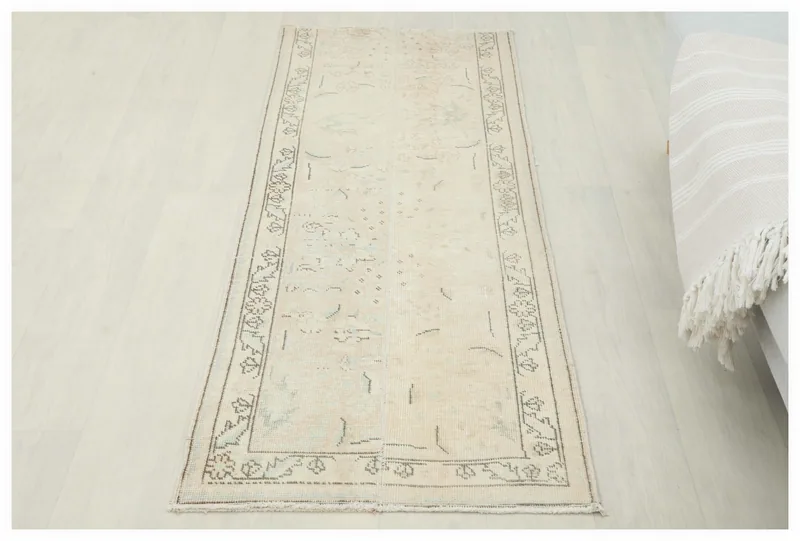 Full top view of the beige Anatolian vintage runner rug on a white background.