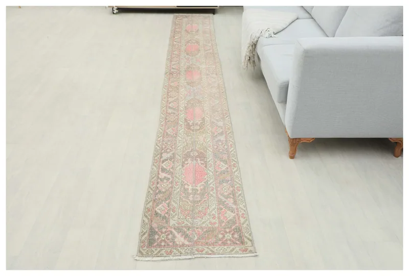 Full top view of the 1'8" x 12'5" vintage Anatolian runner rug with rose and beige geometric patterns