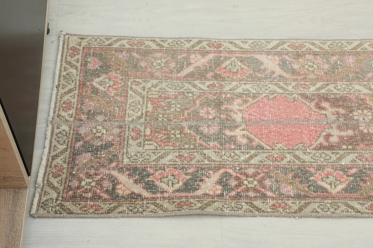 Detailed view showing the intricate geometric patterns and color variations, including rose, beige, and brown