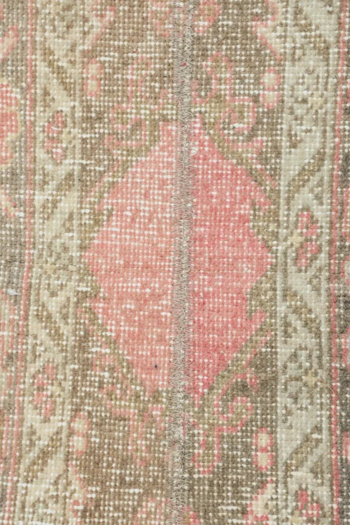 Detailed shot highlighting a central rose geometric medallion and the surrounding patterns