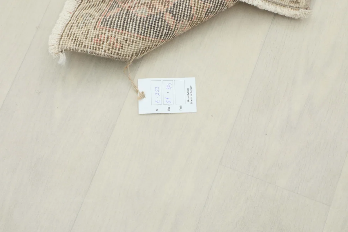 Close-up of the care tag attached to the vintage Anatolian runner rug