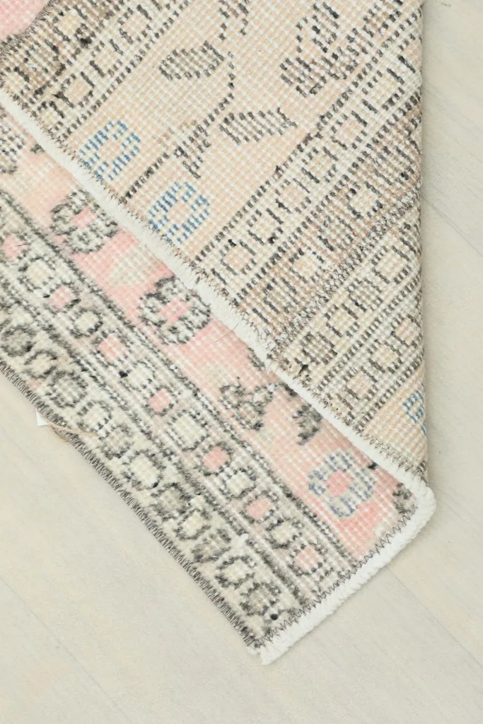 View of the back of the hand-knotted wool runner, revealing the cotton foundation.