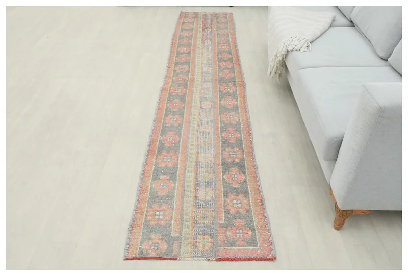 Full top view of the 2'1" x 10'0" vintage Anatolian runner rug on a white background