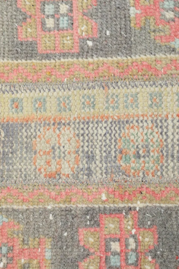 Close-up of the intricate hand-knotted wool pile and specific tribal motifs