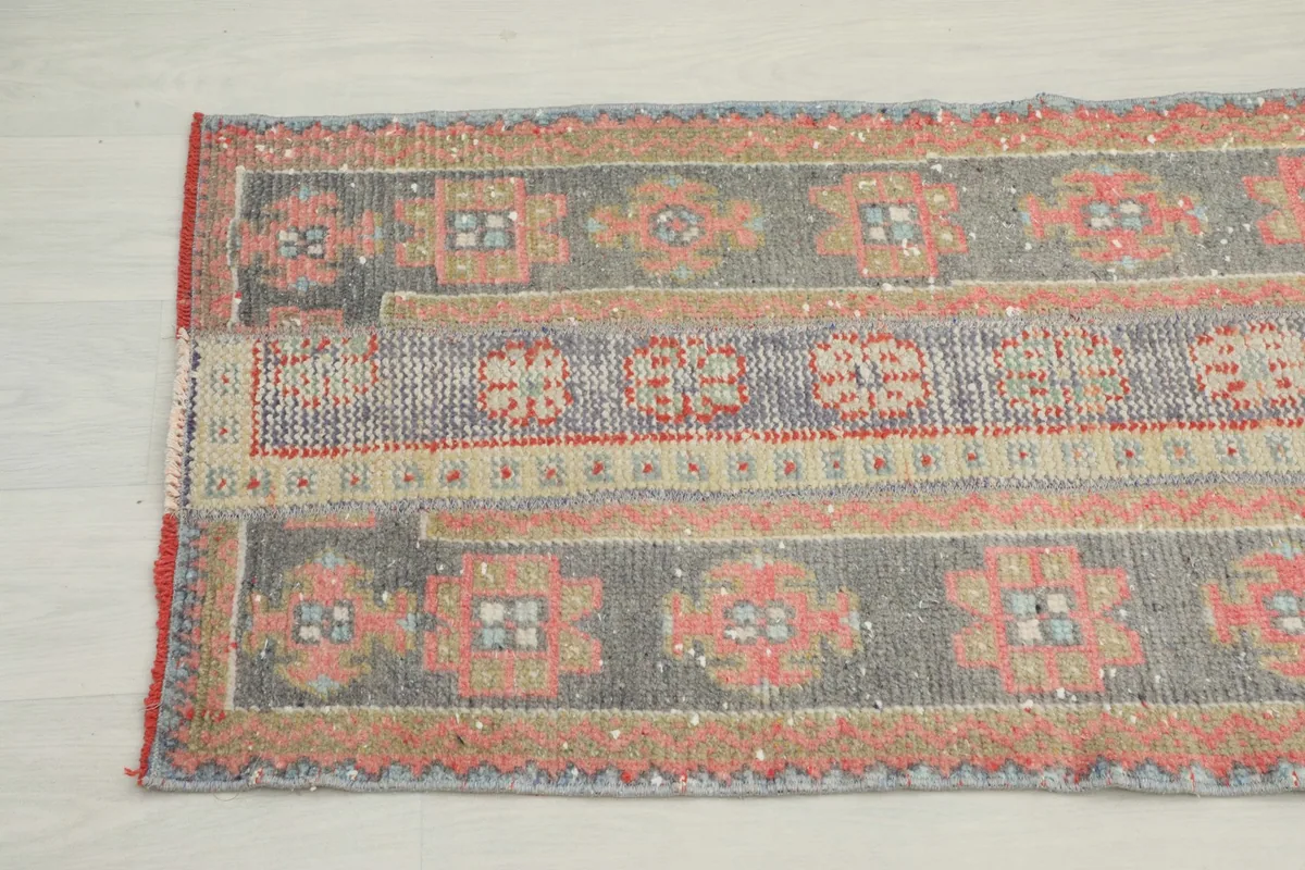 View of the rug's low wool pile and hand-knotted construction, with a slight fold