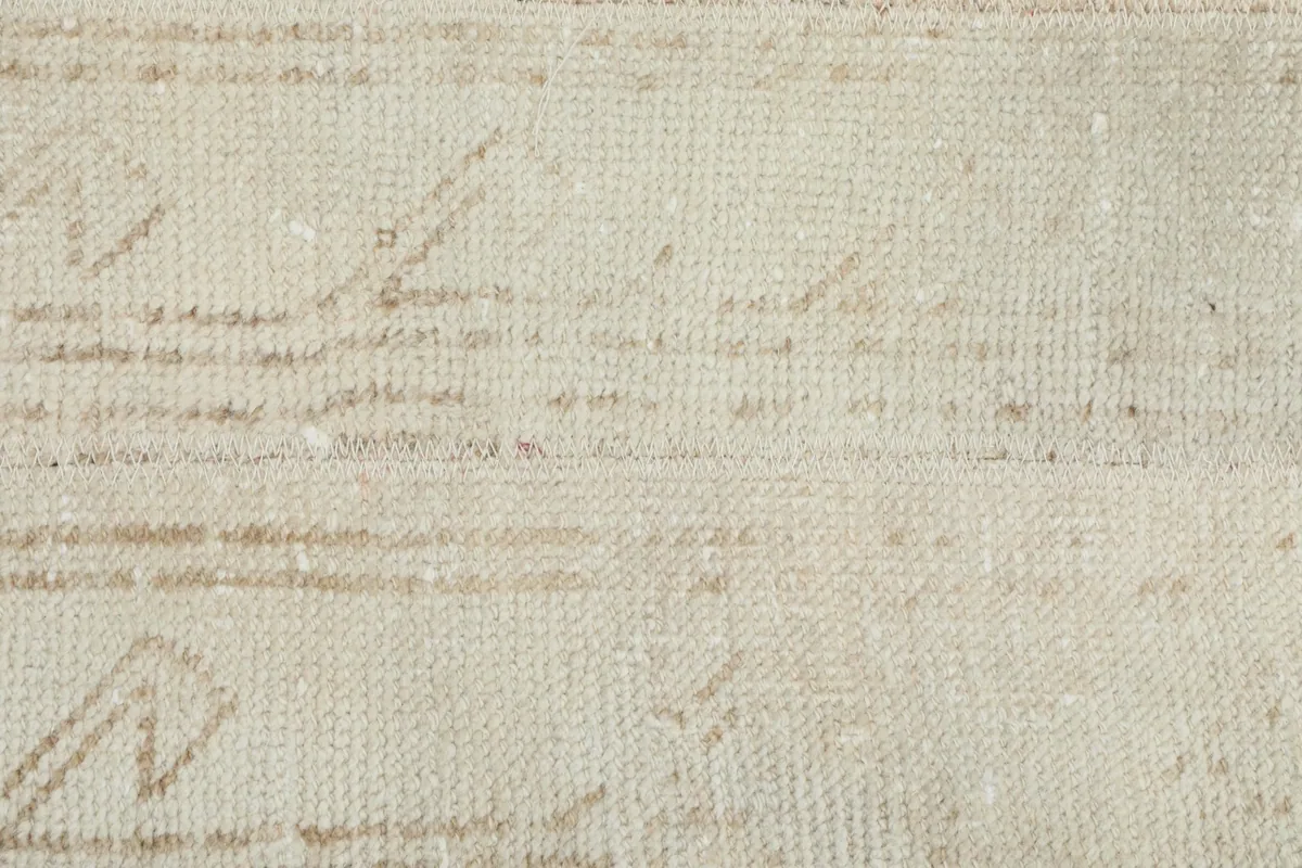 Extreme close-up of the wool pile, revealing the individual knots and subtle patterns within the field.