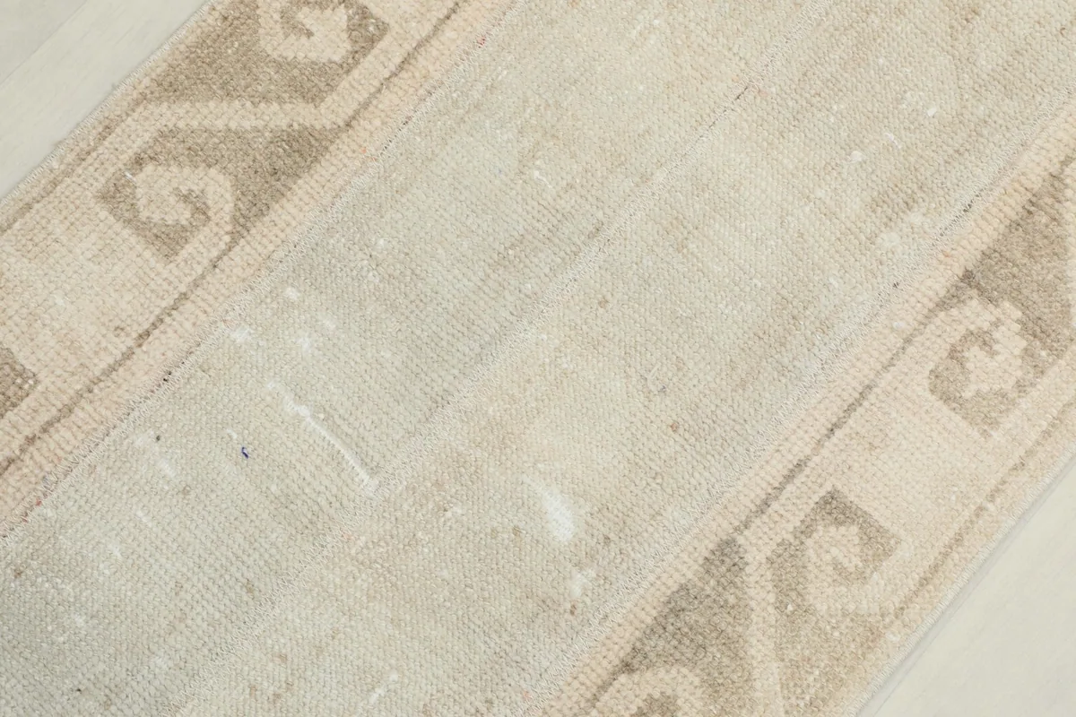 Close-up showing the low pile texture and hand-knotted wool construction of the rug.