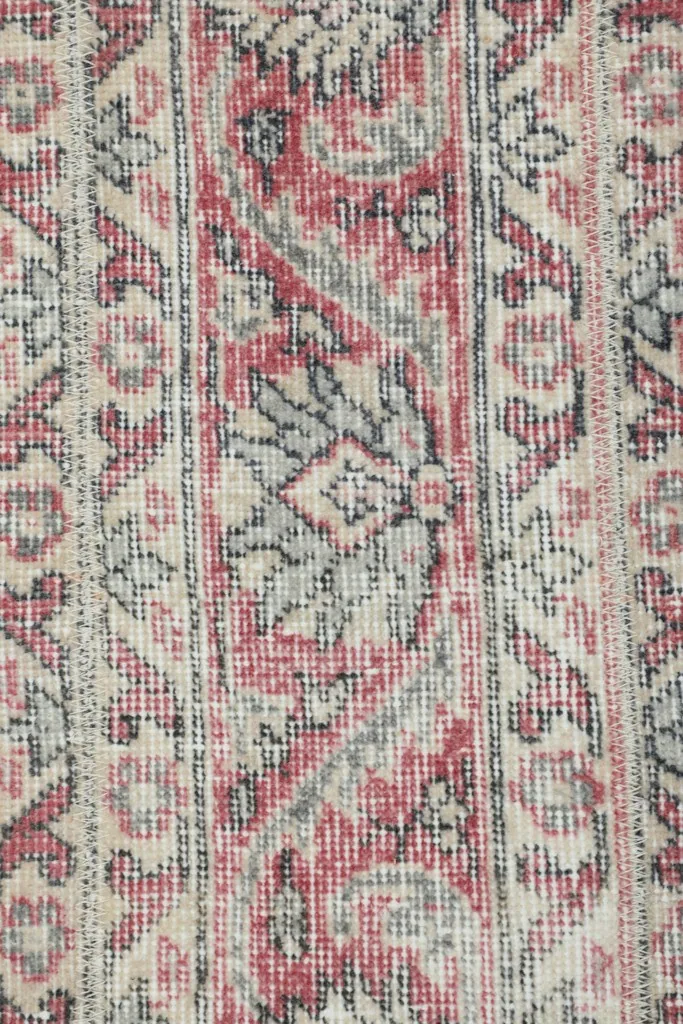 Extreme close-up of the low wool pile, showing individual knots and color variations.