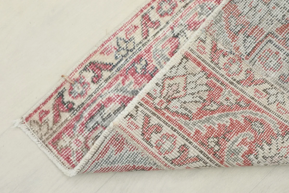 Underside view of a folded corner, showing the cotton foundation and hand-knotting.