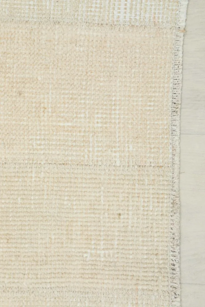 View of the back of the rug, showing the consistent hand-knotted cotton foundation