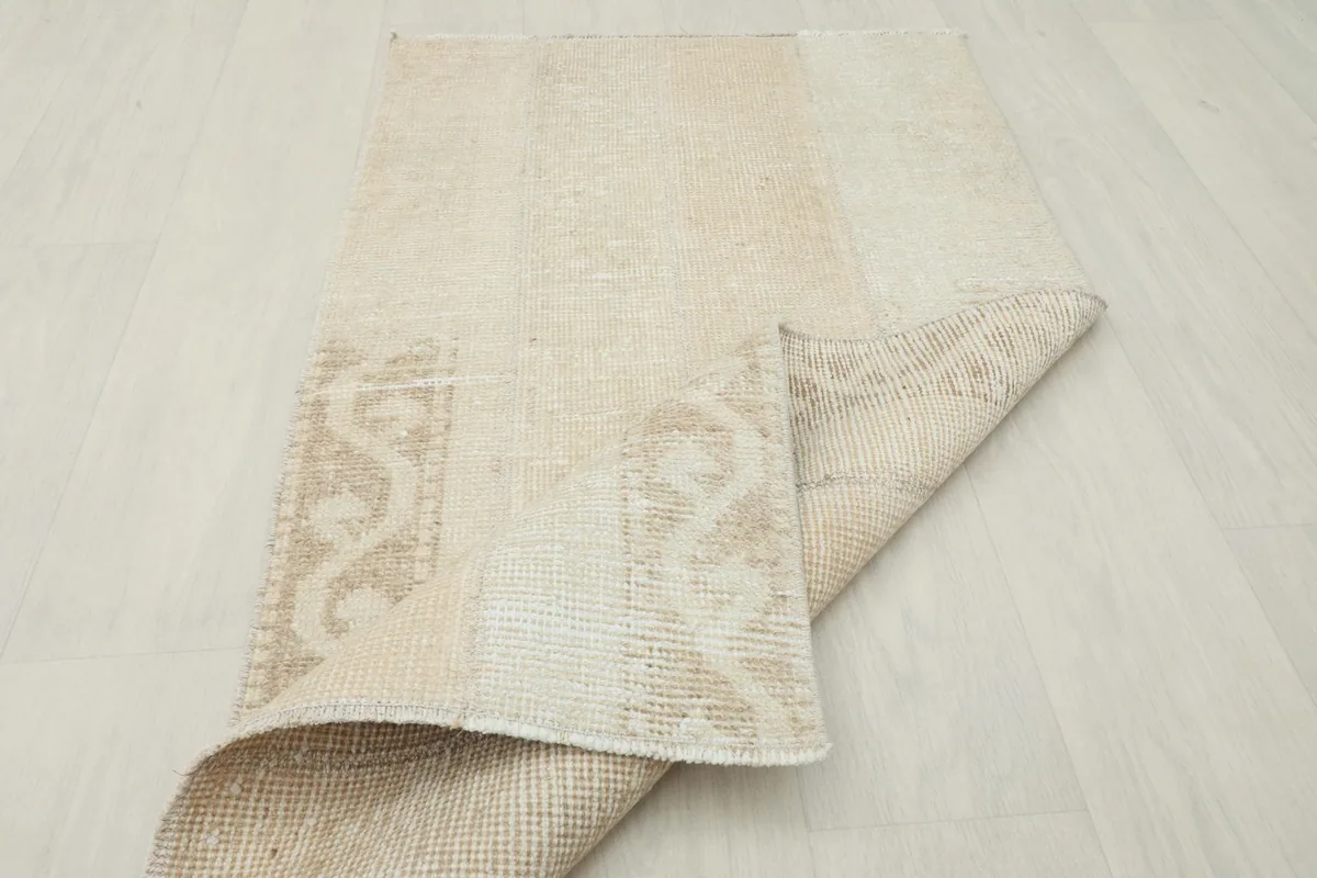 Rug corner folded to show the thickness and the hand-knotted construction from the side