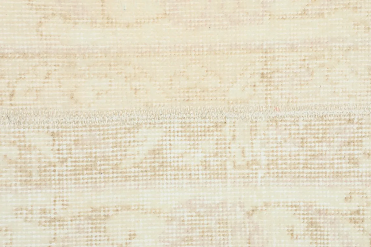 Extreme close-up of the low wool pile, revealing the hand-knotted texture and foundation.