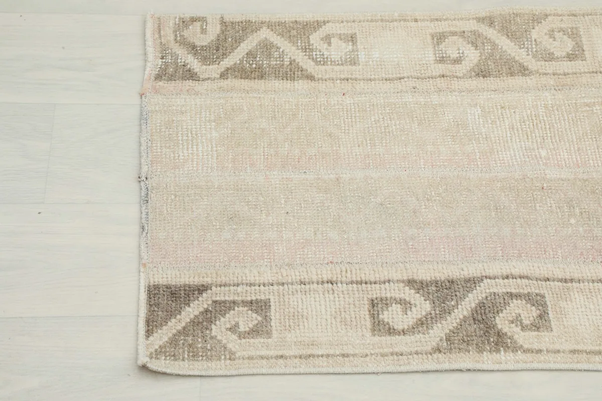 Detail view of the rug's corner showcasing the distressed texture and border