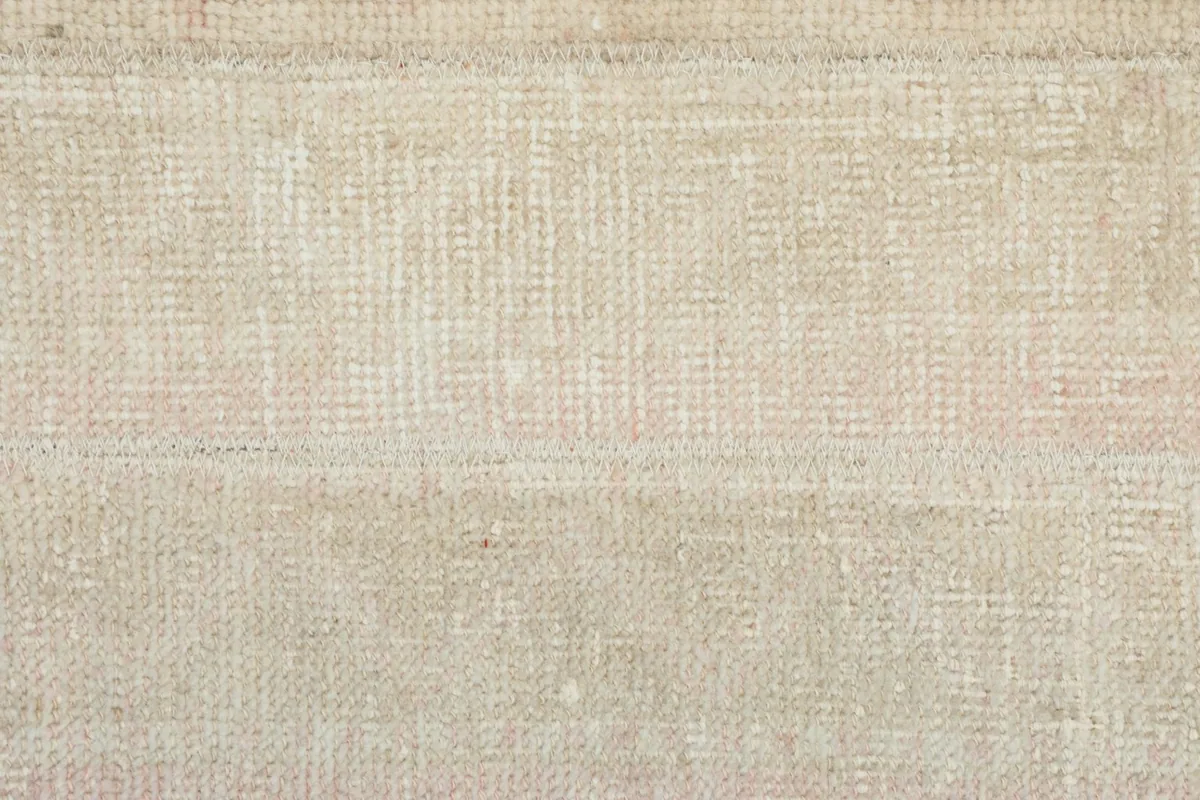 Close view of the rug's surface texture, highlighting the hand-knotted wool pile