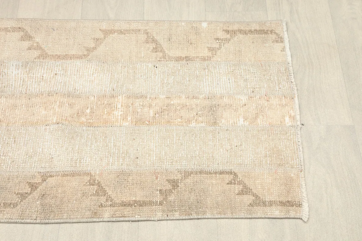 Detailed shot of the rug's corner, highlighting the natural color variations and subtle patterns.