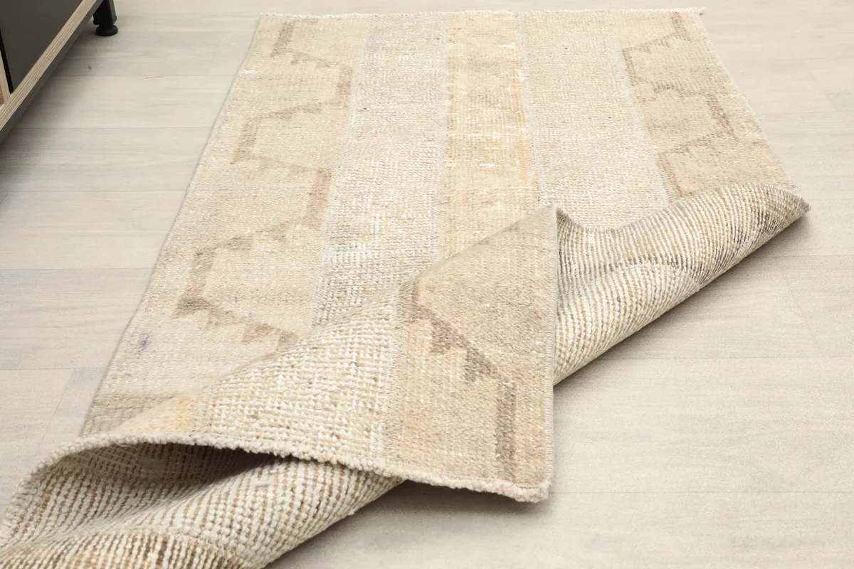 The rug partially folded, demonstrating its flexibility and material thickness.