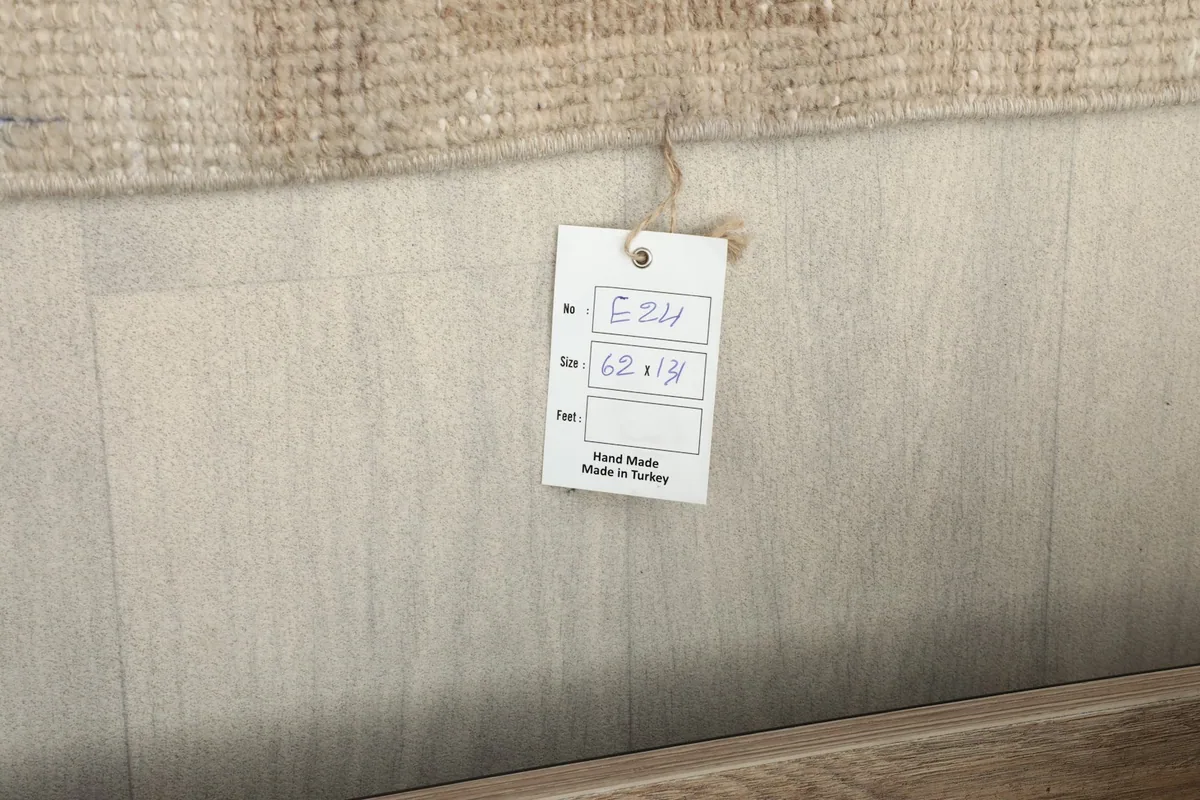 Product tag showing the rug's dimensions and origin: hand-made in Turkey.