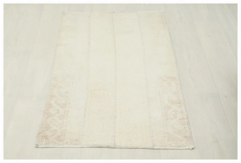Full top view of the 2x4 ivory and beige vintage Anatolian rug on a white background