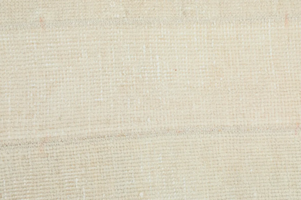 Close-up texture of the hand-knotted wool pile, showing its tight weave and low height