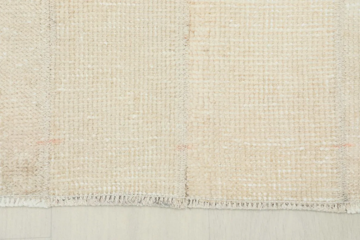 Detail of the short, natural cotton fringe and edge finish of the vintage rug