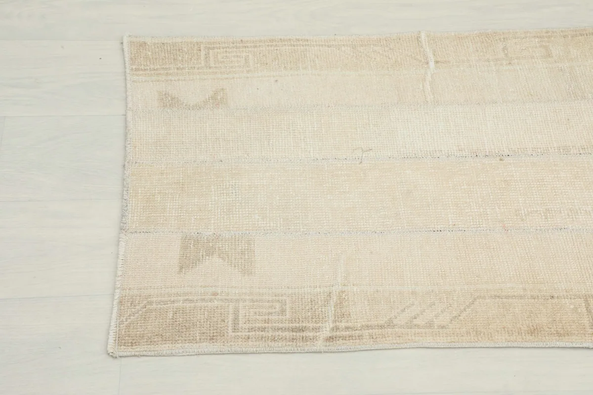 Close-up detail of the rug's opposite end, showcasing the tribal geometric patterns and color variations.