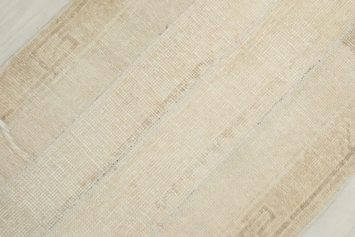 Detailed close-up of the rug's low wool pile and the hand-knotted texture.