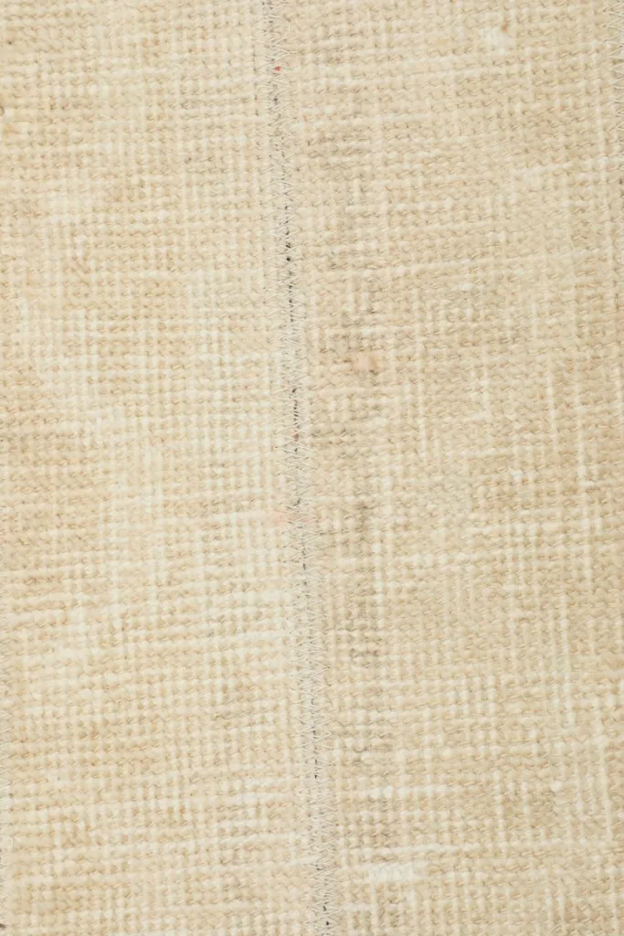 Close view of the wool pile and cotton foundation weave, showing the hand-knotted construction.