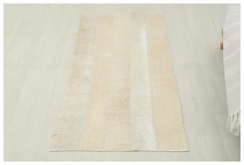 Full overhead view of the 2x4 cream and beige striped vintage Anatolian wool rug