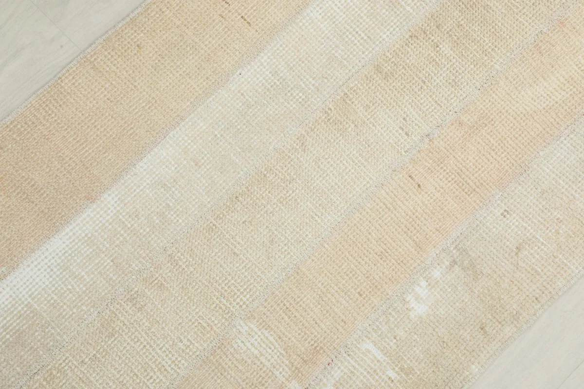 Diagonal detail shot highlighting the striped design and low pile of the Anatolian rug