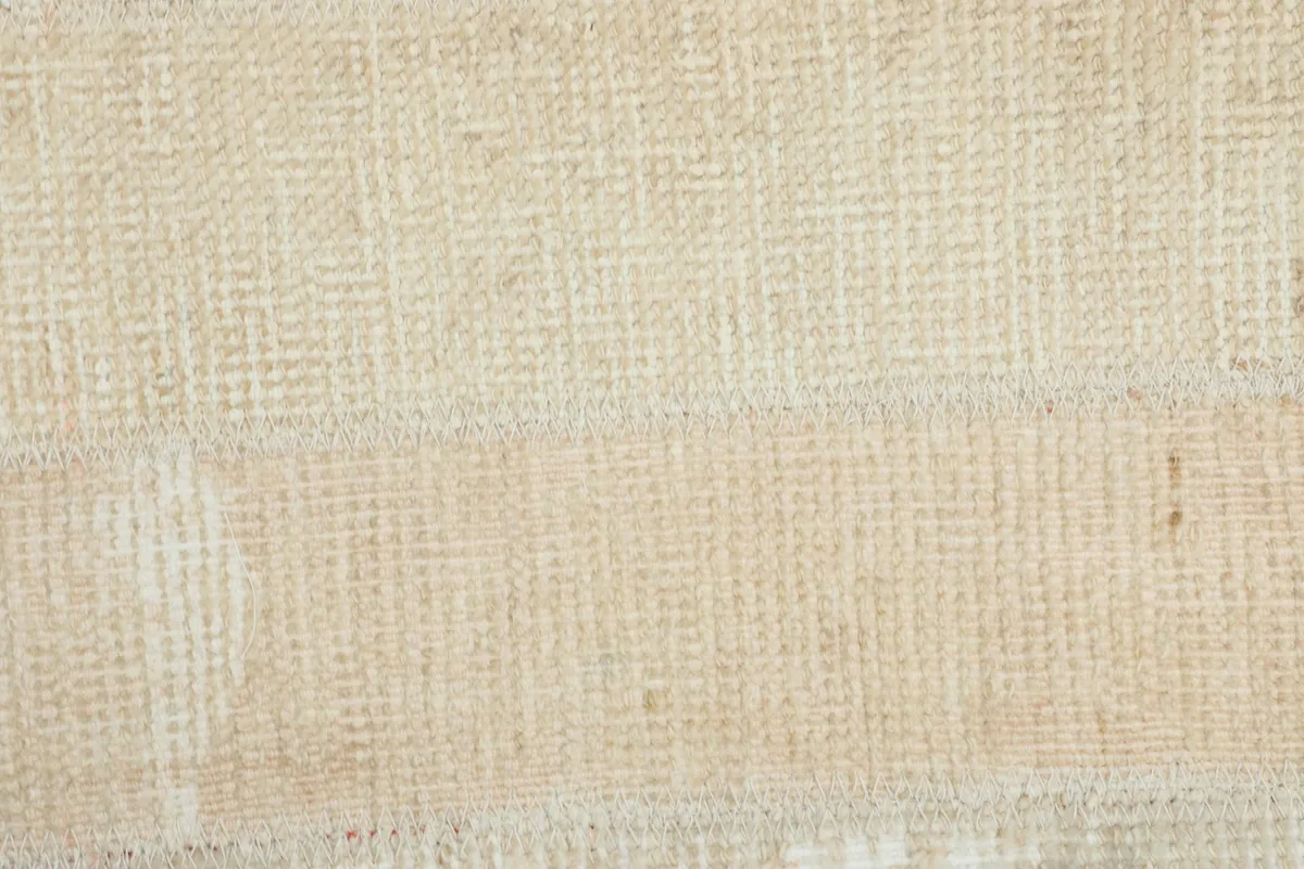 Macro detail of the hand-knotted wool pile and cotton foundation visible in the rug