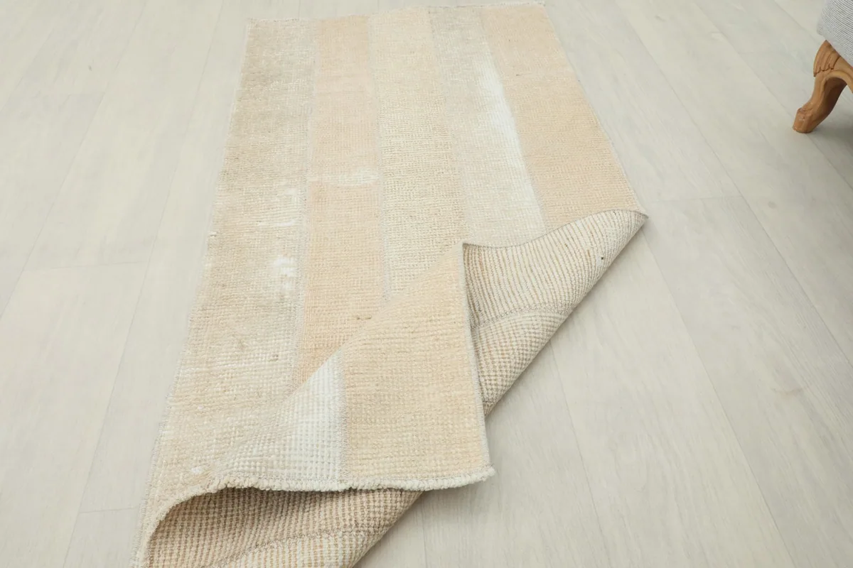Rug partially folded, showing the flexibility and thickness of the vintage wool piece