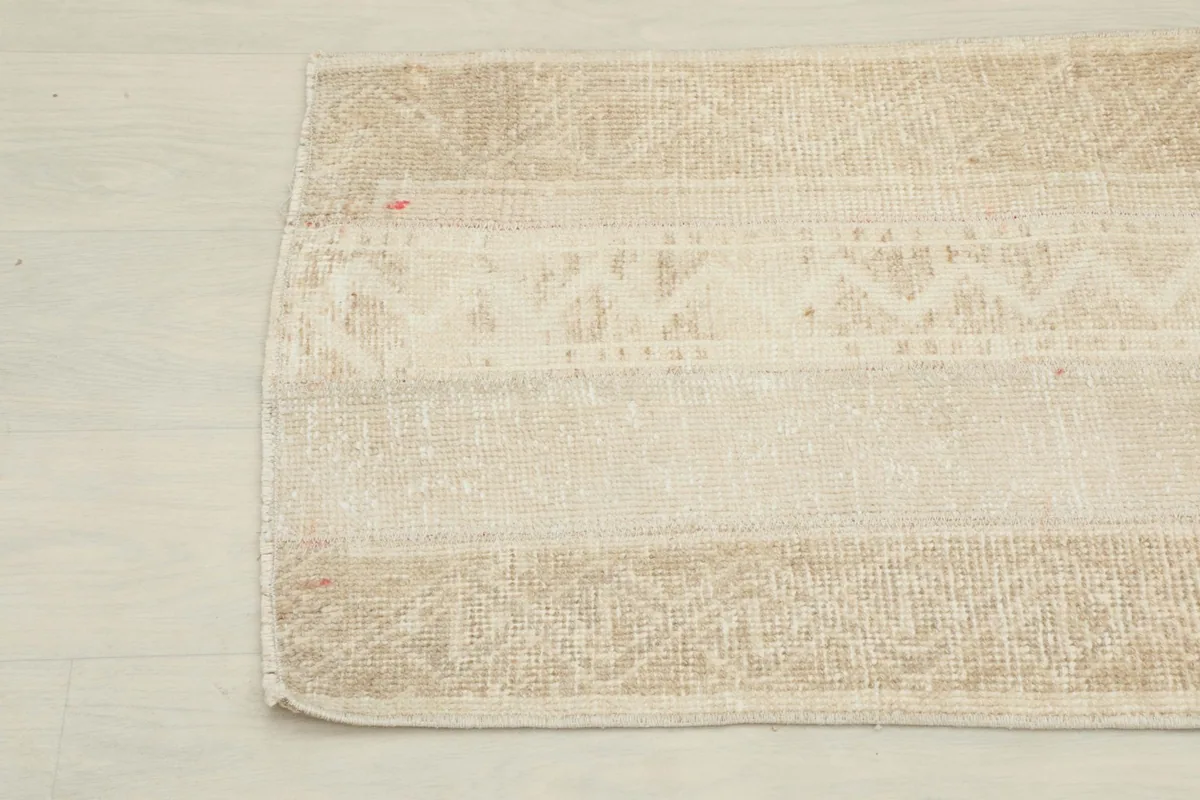 Close-up detail of the geometric striped pattern and texture on the right side of the rug.