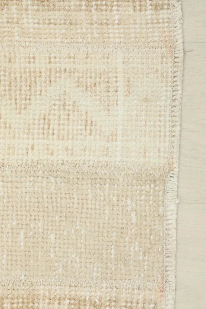 Close-up of the finished edge and side border of the vintage Anatolian rug.