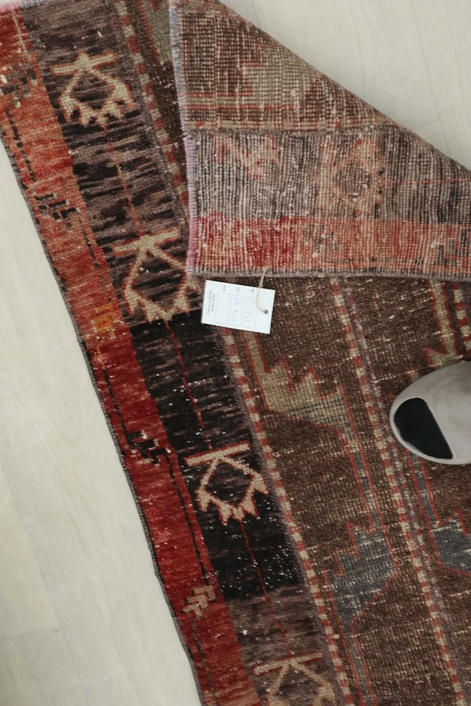 Close-up of the rug's reverse side, revealing the hand-knotted construction and cotton foundation.