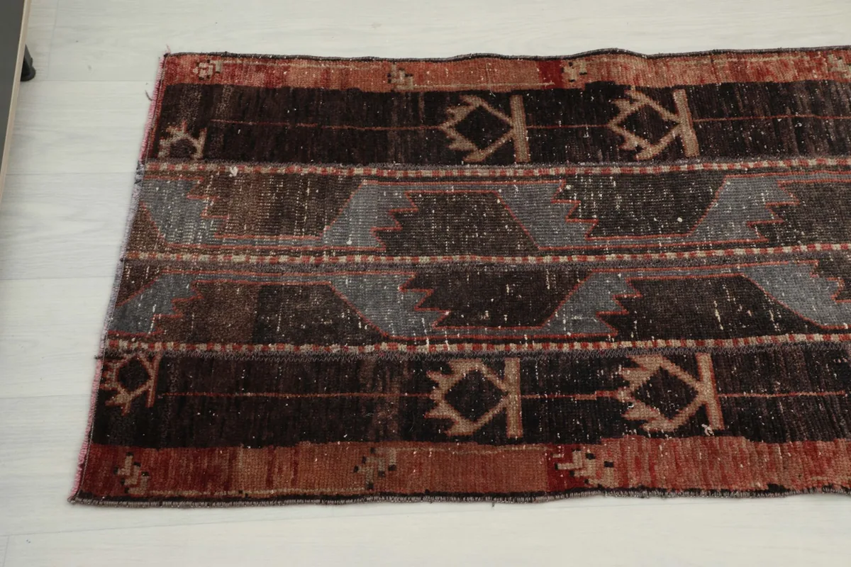 Close-up of the vintage runner's surface, highlighting the various colors and the low pile texture.