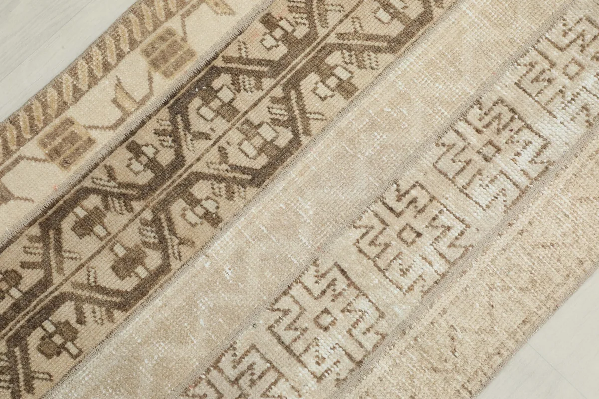 Overhead close-up showing the varied striped patterns and subtle color shifts across the rug's surface.