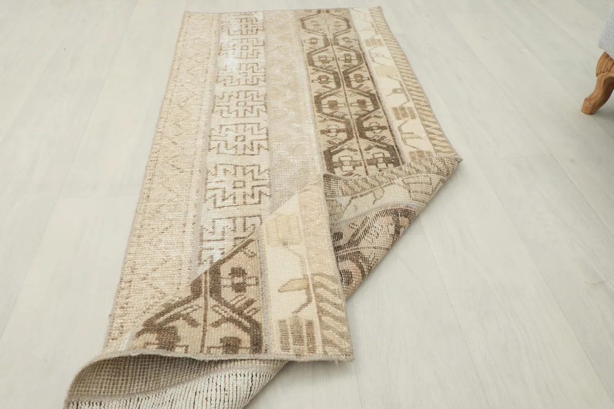 Rug partially folded to show its flexibility and the consistent pattern from top to bottom.