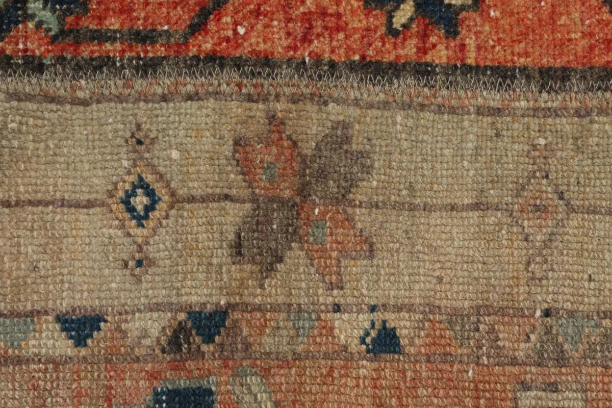 Extreme close-up of the wool pile and knotting, showing individual fibers and color blending.