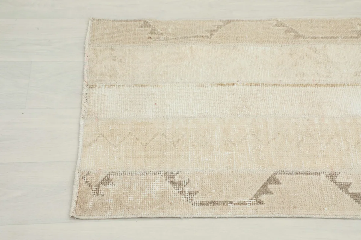 Another close-up of the rug's end, revealing the intricate hand-knotted texture and soft color transitions.