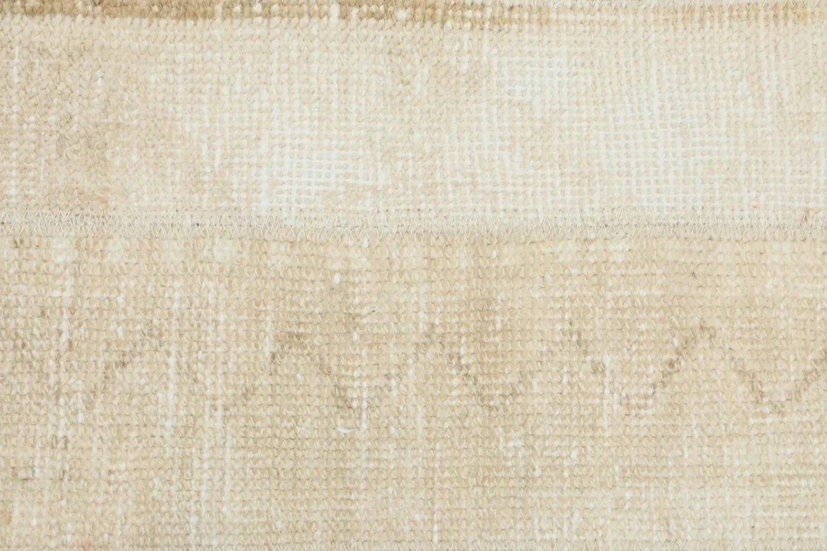 Very close view of the low wool pile, showing the hand-knotted construction and natural texture of the fibers.
