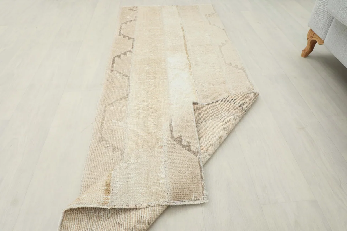 The runner rug partially folded, illustrating its flexibility and the consistent hand-knotted quality.
